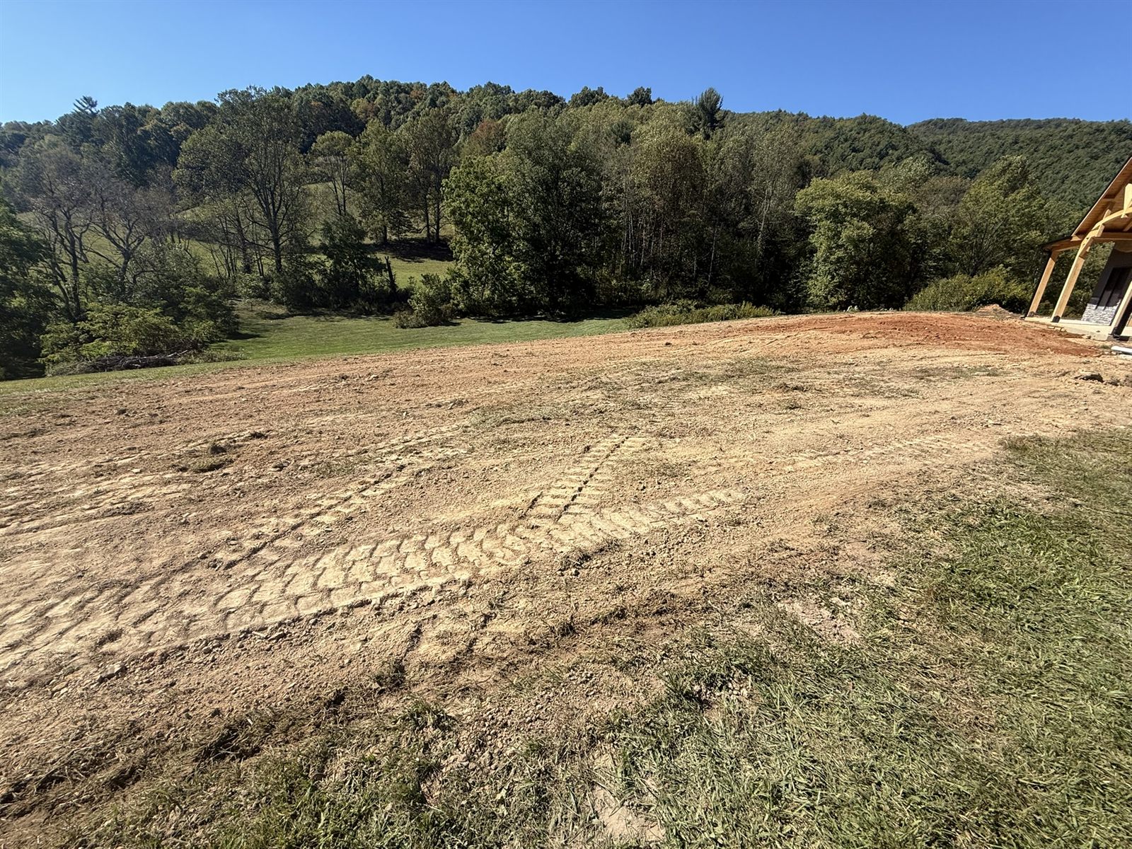 Freshly graded building pad with a mountain backdrop in Western NC