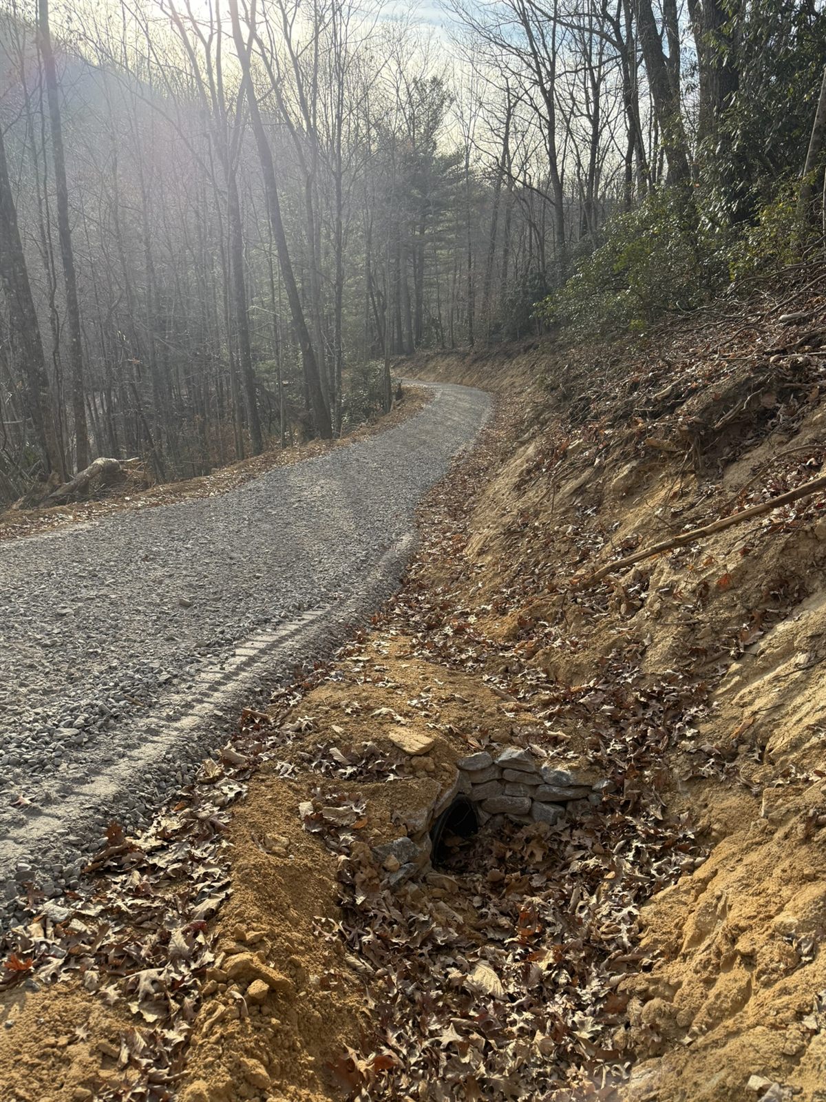 Gravel road with a stone culvert headwall in Western NC