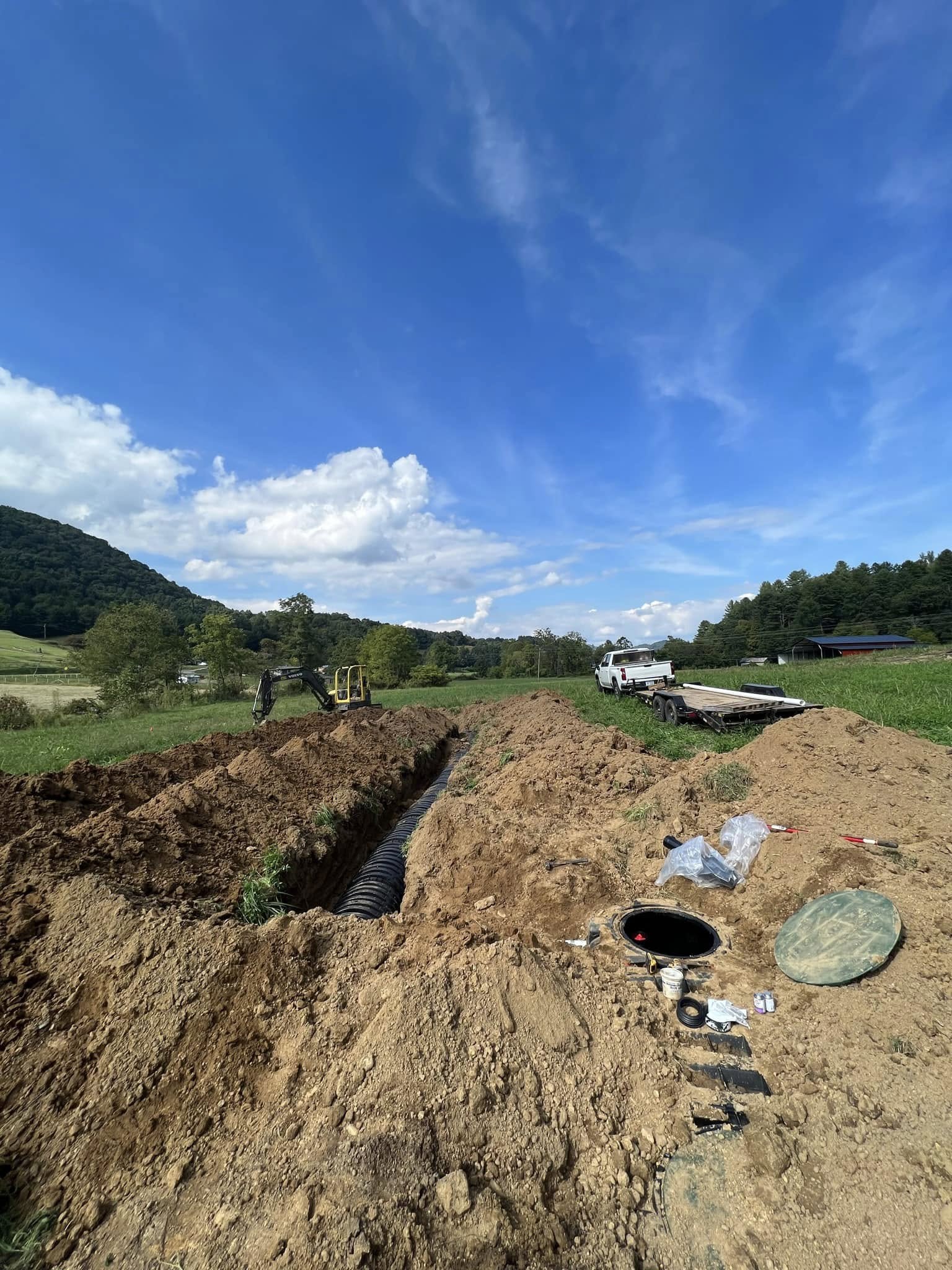 Drainage and septic drain-field lines trenched across a site in Western NC